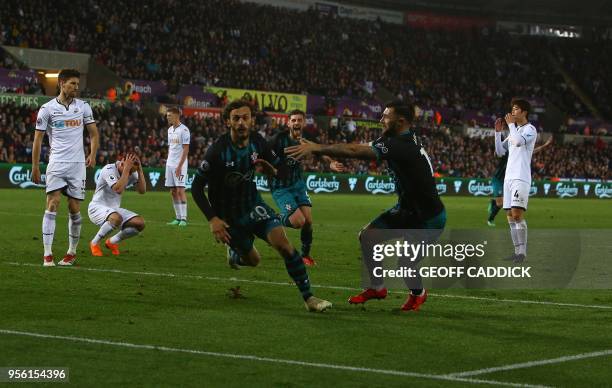 Southampton's Italian striker Manolo Gabbiadini celebrates scoring his team's first goal with Southampton's English striker Charlie Austin during the...