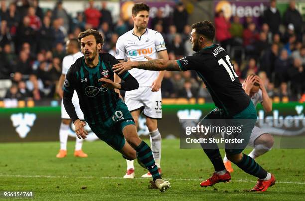 Manolo Gabbiadini of Southampton celebrates with Charlie Austin after he scores his sides first goal during the Premier League match between Swansea...