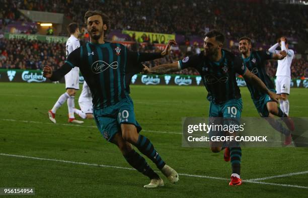 Southampton's Italian striker Manolo Gabbiadini celebrates scoring his team's first goal with Southampton's English striker Charlie Austin during the...