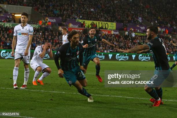 Southampton's Italian striker Manolo Gabbiadini celebrates scoring his team's first goal with Southampton's English striker Charlie Austin during the...