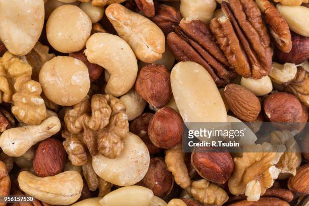 lot of different types of nuts mix for background - nuts stock pictures, royalty-free photos & images