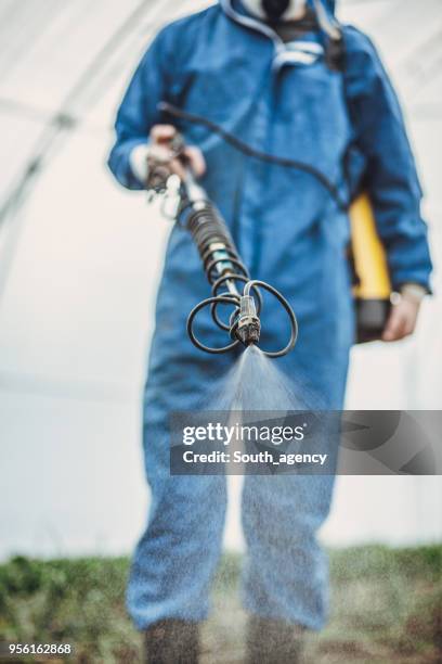 man crop spraying - pest stock pictures, royalty-free photos & images