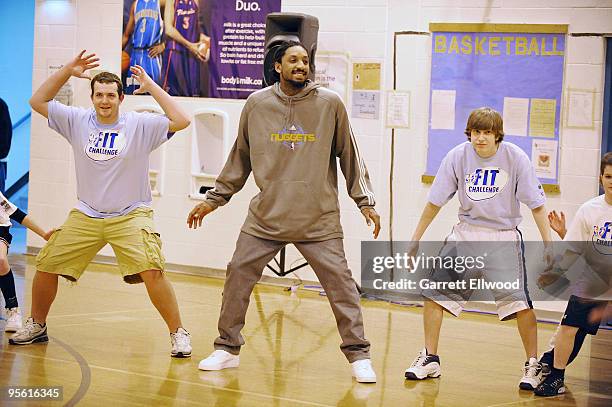 Renaldo Balkman of the Denver Nuggets joins students in a basketball drill at West Middle School as part of the Nuggets Team Fit and NBA Fit Week...