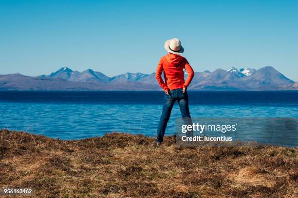 active senior on coastal walk, scotland - hands in pockets stock pictures, royalty-free photos & images
