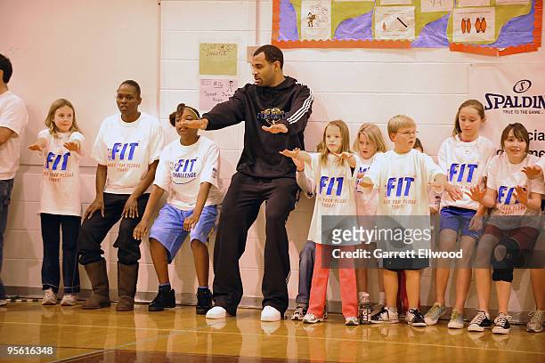 Malik Allen of the Denver Nuggets joins students in a basketball drill at West Middle School as part of the Nuggets Team Fit and NBA Fit Week...