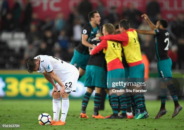 Connor Roberts of Swansea City looks dejected as Southampton celebrate victory during the Premier League match between Swansea City and Southampton...