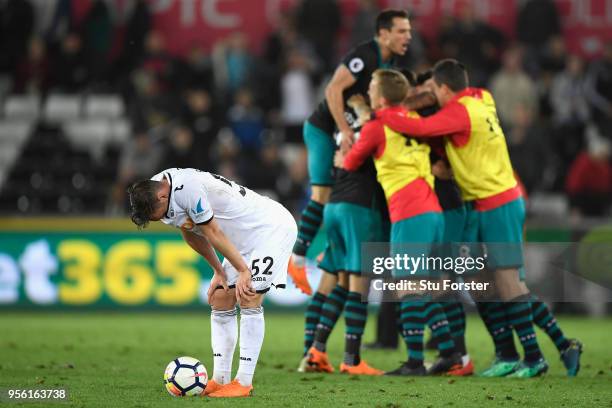 Connor Roberts of Swansea City looks dejected as Southampton celebrate victory during the Premier League match between Swansea City and Southampton...