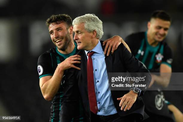 Sam McQueen of Southampton celebrates with Mark Hughes, Manager of Southampton during the Premier League match between Swansea City and Southampton...
