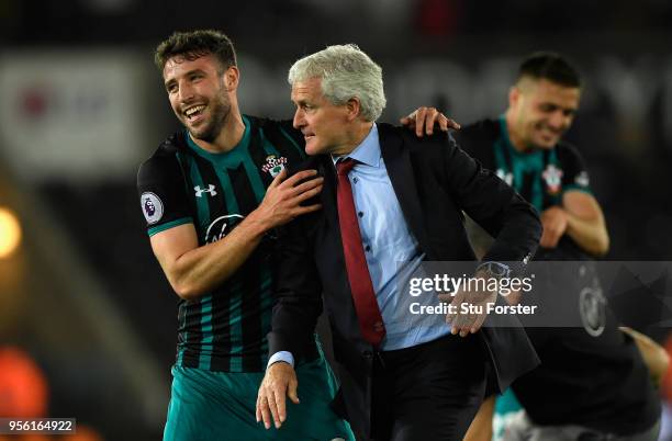 Sam McQueen of Southampton celebrates with Mark Hughes, Manager of Southampton during the Premier League match between Swansea City and Southampton...