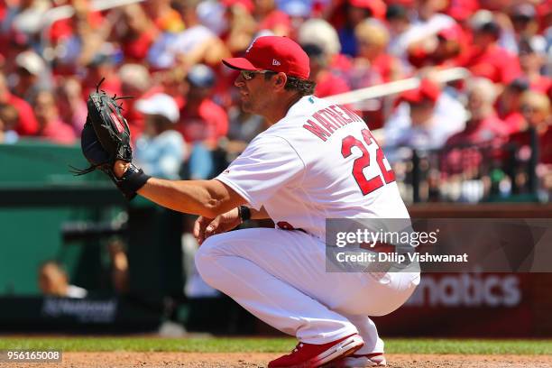 Manager Mike Matheny of the St. Louis Cardinals catches during warm-ups in the ninth inning against the Minnesota Twins at Busch Stadium on May 8,...