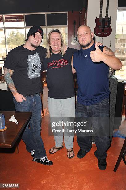 Nicko McBrain of Iron Maiden poses with Robb Rivera and Zach Broderick of Nonpoint at his restaurant Rock N Roll Ribs on January 6, 2010 in Coral...