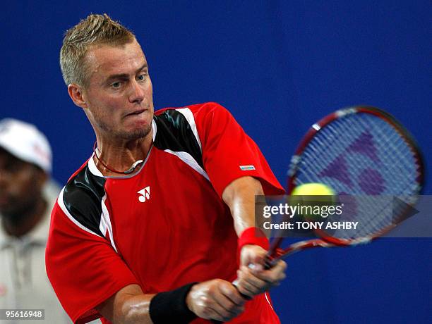 Lleyton Hewitt of Australia returns against Tommy Robredo of Spain during their singles match on the ninth session, day six of the Hopman Cup in...