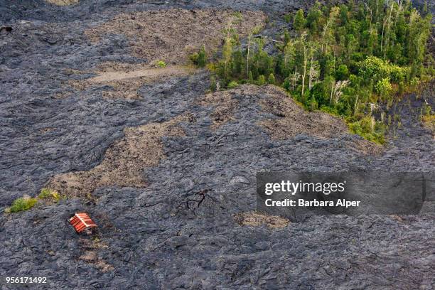 Aerial view of a house surrounded by hardened lava from a previous volcano eruption on the island of Hawaii, Hawaii, December 21, 2007.