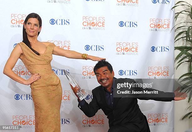 Actress Sandra Bullock and comedian George Lopez pose with Bullock's Favorite Movie Actress award in the press room during the People's Choice Awards...