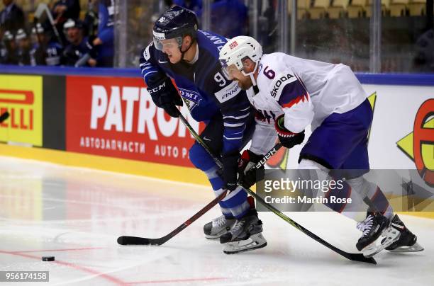 Mikko Rantanen of Finland and Jonas Holos of Norway battle for the puck during the 2018 IIHF Ice Hockey World Championship group stage game between...