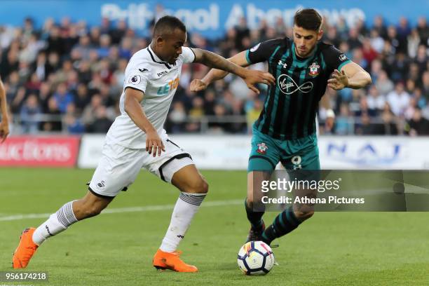 Jordan Ayew of Swansea City challenged by Wesley Hoedt of Southampton during the Premier League match between Swansea City and Southampton at The...