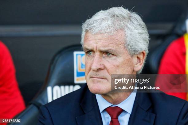 Southampton manager Mark Hughes sits on his bench during the Premier League match between Swansea City and Southampton at The Liberty Stadium on May...