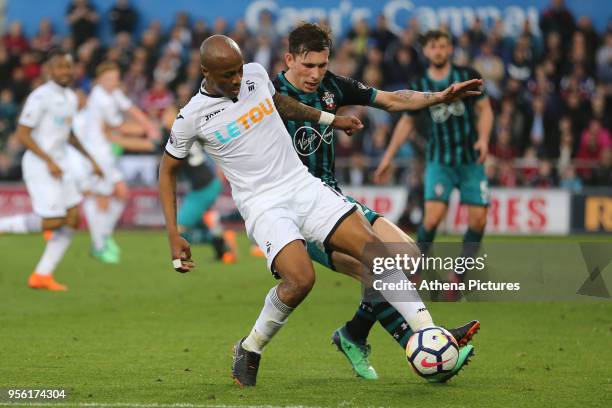 Andre Ayew of Swansea City closely followed by Pierre-Emile Hojbjerg of Southampton during the Premier League match between Swansea City and...