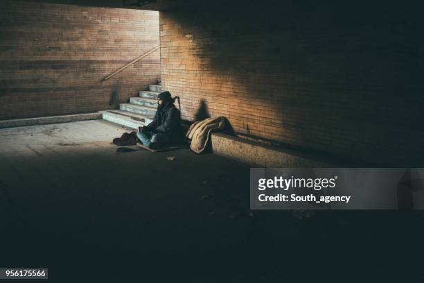 homeless guy sitting alone - homeless man stock pictures, royalty-free photos & images