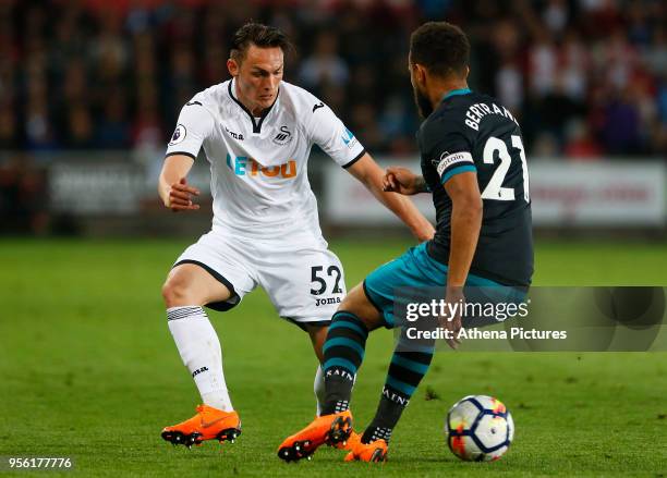 Connor Roberts of Swansea City is marked by Ryan Bertrand of Southampton, during the Premier League match between Swansea City and Southampton at...