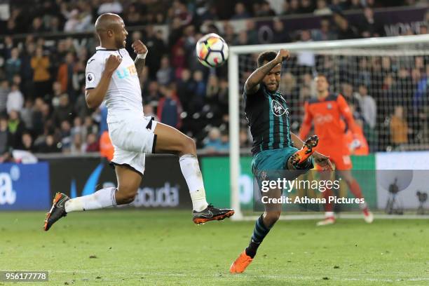 Kicks the ball away from Andre Ayew of Swansea City during the Premier League match between Swansea City and Southampton at The Liberty Stadium on...