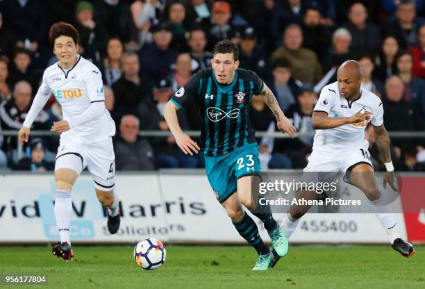 Pierre-Emile Hojbjerg of Southampton runs past Ki Sung-Yueng of Swansea City and Andre Ayew of Swansea City during the Premier League match between...