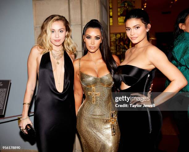 Mylie Cyrus, Kim Kardashian West and Kylie Jenner attend Heavenly Bodies: Fashion & The Catholic Imagination Costume Institute Gala at The...