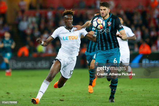 Tammy Abraham of Swansea City is challenged by Wesley Hoedt of Southampton during the Premier League match between Swansea City and Southampton at...