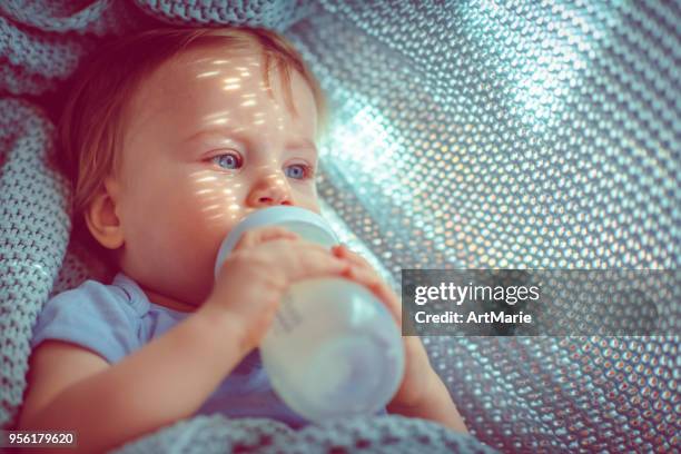 cute baby boy drinking milk - milk bottle stock pictures, royalty-free photos & images