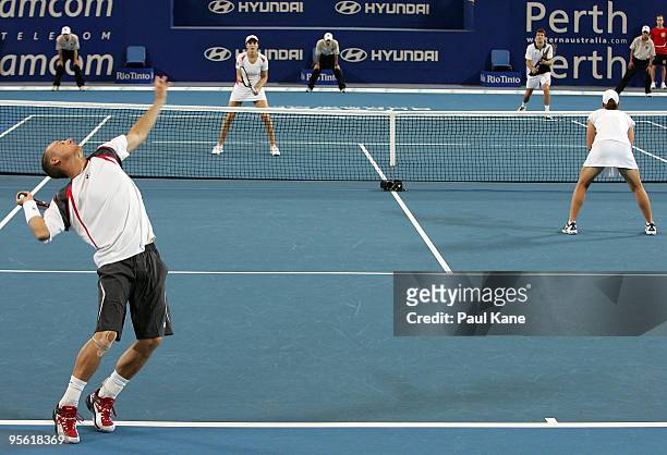 Lleyton Hewitt and Samantha Stosur of Australia compete in their mixed doubles match against Tommy Robredo and Maria Jose Martinez Sanchez of Spain...