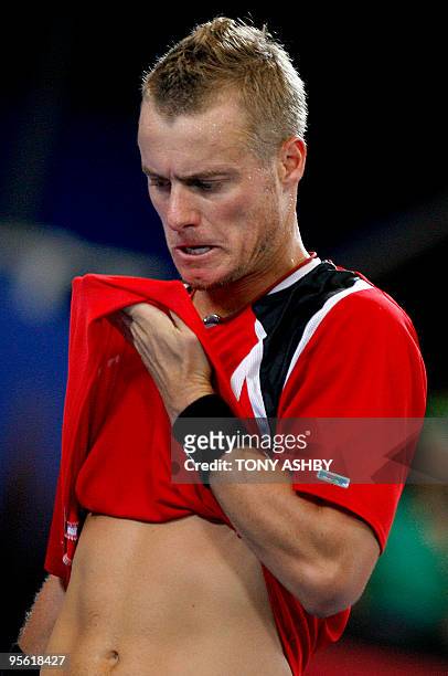 Lleyton Hewitt of Australia wipes his face during a pause in the action against Tommy Robredo of Spain in their men's singles match on the ninth...