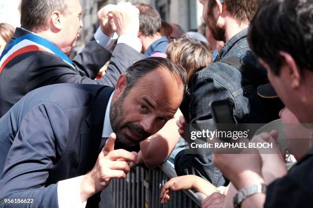 French Prime Minister Edouard Philippe greets people during the Johannique celebrations in tribute to Jeanne DArc on May 8, 2018 in Orleans, central...