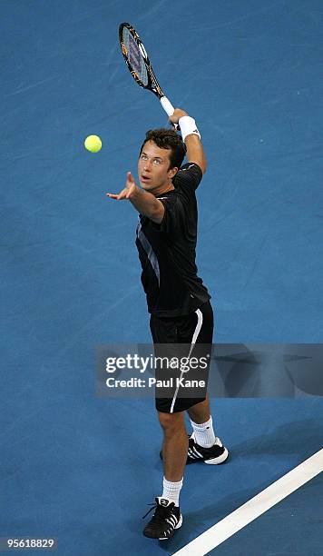 Victor Hanescu of Romania serves in his match against John Isner of the USA in the Group B match between the USA and Romania during day six of the...