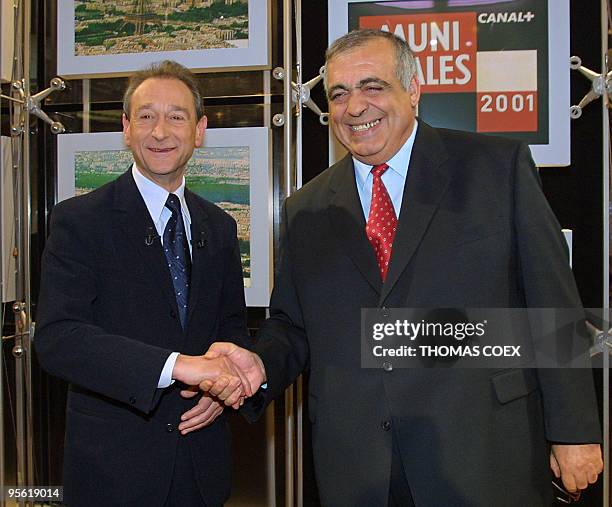 French Socialist Paris candidate Bertrand Delanoe , shakes hands with neo-Gaullist RPR counterpart Phillipe Seguin, 28 February 2001 in the studios...