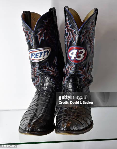 Pair of M.L. Leddy brand handmade cowboy boots featuring a "Petty" emblem and the number "43" are displayed at Julien's Auctions' preview of a...