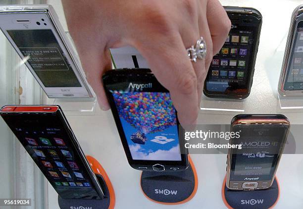 Samsung Electronics Co.'s Anycall brand mobile phones are displayed at electronic shop in Seoul, South Korea, on Thursday, Jan. 7, 2010. Samsung...