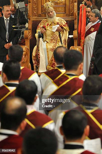 Pope Shenuda III , the head of the Egyptian Coptic Orthodox church, blesses bread to be handed out to worshippers during Christmas midnight mass,...
