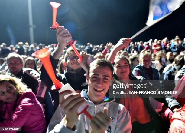 Supporters of French third division football club 'Les Herbiers' react at the stadium in Les Herbiers, western France, on May 8 as they watch on a...