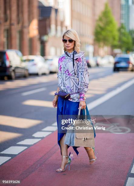 Gitta Banko wearing a midnight blue asymmetrical leather skirt from Topshop, hoody with printed floral and Bauhaus pattern by Dawid Tomaszewski,...