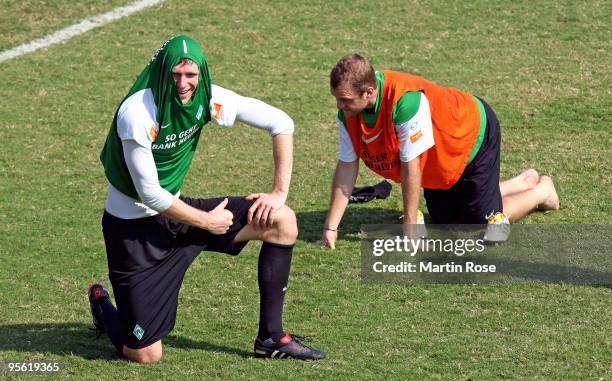 Per Mertesacker of Bremen protects his head against the heat during the Werder Bremen training session at the Al Wasl training ground on January 7,...