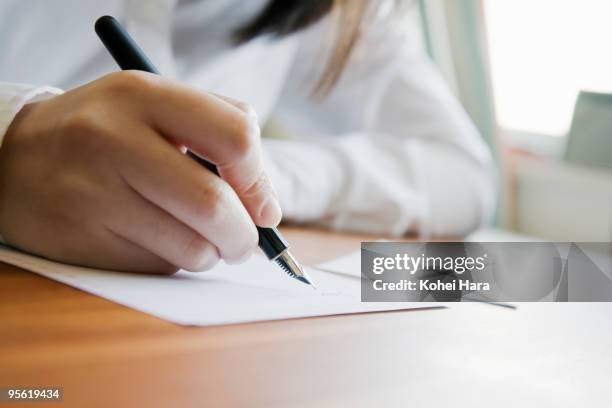 woman writing a letter - pen ストックフォトと画像