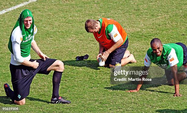 Per Mertesacker of Bremen protects his head against the heat during the Werder Bremen training session at the Al Wasl training ground on January 7,...