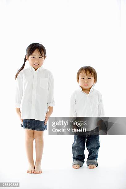 two children line up and it stands - boy jeans stock pictures, royalty-free photos & images