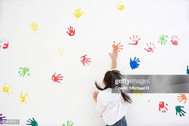 children making handprints with paint - paint handprint stock pictures, royalty-free photos & images