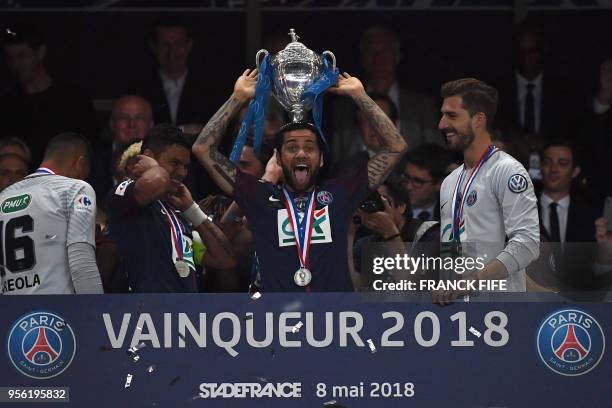 Paris Saint-Germain's Brazilian defender Daniel Alves celebrates with the trophy at the end of the French Cup final football match between Les...