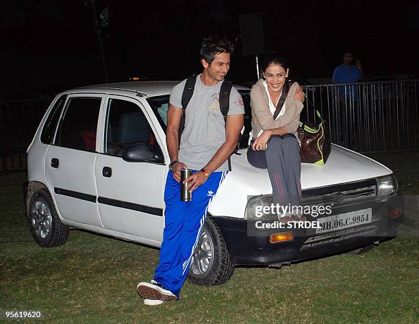 Indian Bollywood actor Shahid Kapoor and actress Genelia D�Souza sit on a car at a promotion ceremony for the film 'Chance Pe Dance' at Kamlistan...