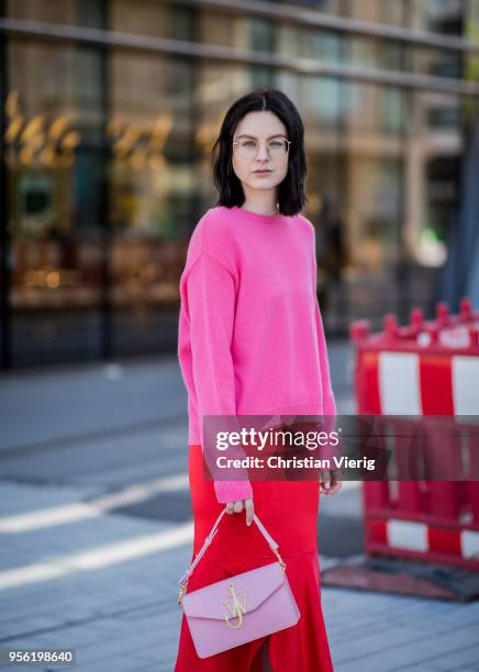 Maria Barteczko wearing pink cashmere sweater Valentino, red silk asymmetric midi skirt Victoria Beckham, light pink bag JW Anderson, light pink...