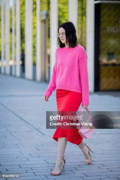 Maria Barteczko wearing pink cashmere sweater Valentino, red silk asymmetric midi skirt Victoria Beckham, light pink bag JW Anderson, light pink...