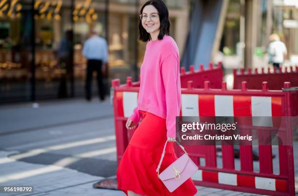 Maria Barteczko wearing pink cashmere sweater Valentino, red silk asymmetric midi skirt Victoria Beckham, light pink bag JW Anderson, light pink...