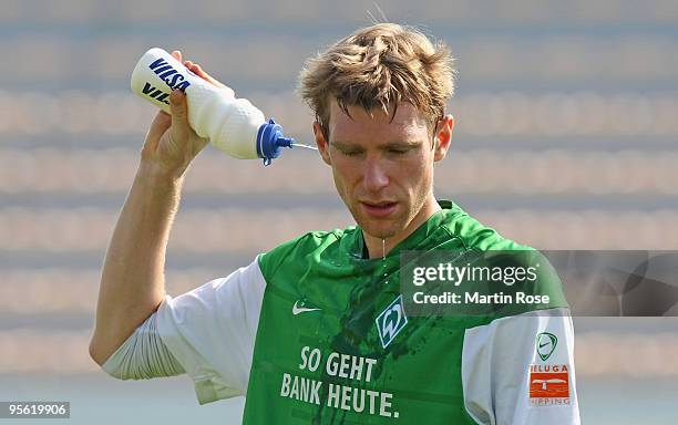 Per Mertesacker of Bremen takes a break during the Werder Bremen training session at the Al Wasl training ground on January 7, 2010 in Dubai, United...